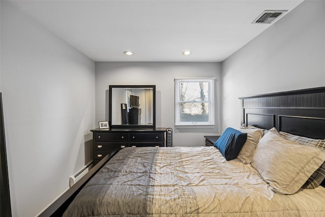 bedroom with a baseboard radiator, visible vents, and recessed lighting