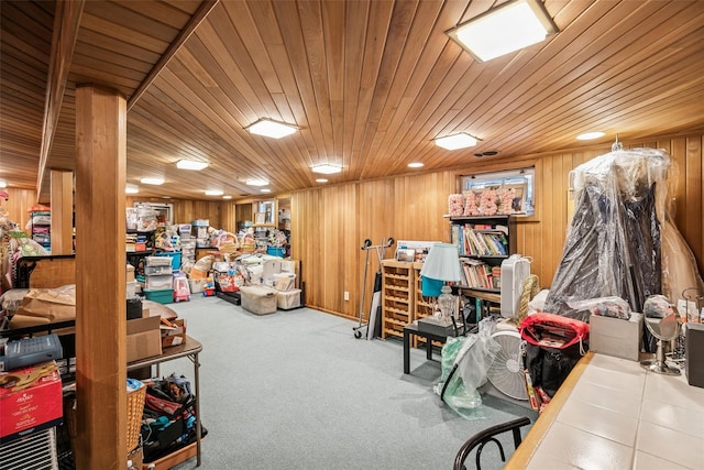 interior space featuring wooden ceiling, carpet, and wooden walls