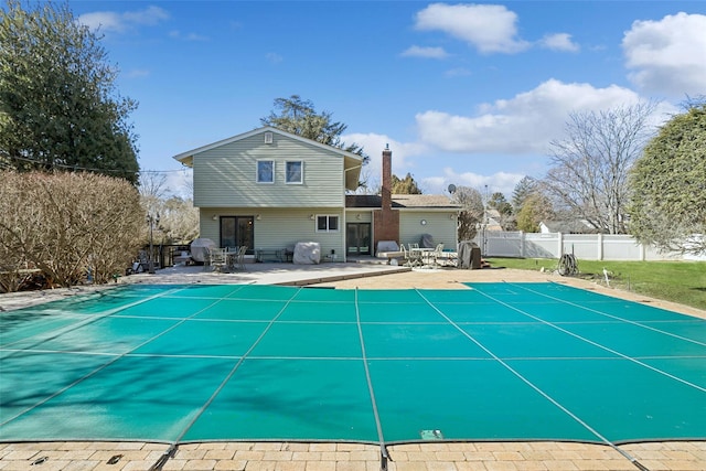 view of swimming pool with a fenced in pool, fence, and a patio