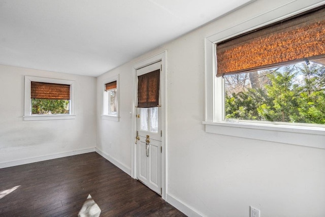 entryway with dark wood-style flooring and baseboards