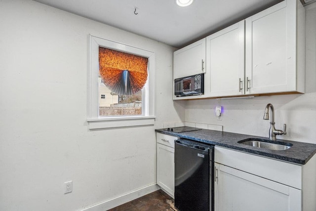 kitchen featuring black appliances, baseboards, white cabinets, and a sink