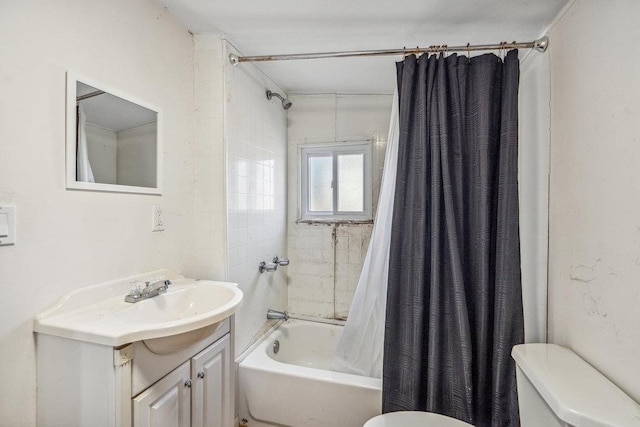 full bath with toilet, shower / bath combo with shower curtain, and vanity