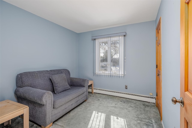 living area with a baseboard heating unit and light colored carpet