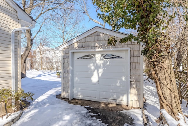 snow covered garage with a garage