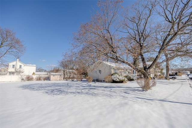 yard covered in snow with a residential view