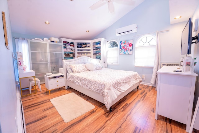 bedroom with lofted ceiling, light wood finished floors, ceiling fan, and an AC wall unit