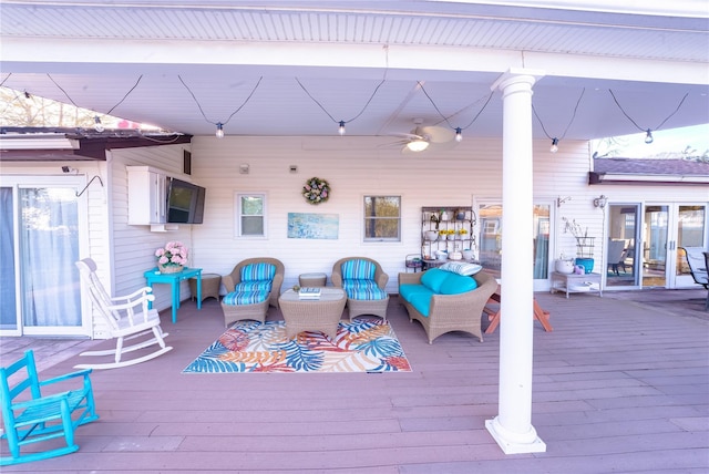 deck featuring outdoor lounge area and a ceiling fan