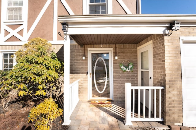 doorway to property with brick siding