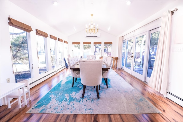 dining room featuring a baseboard radiator, wood finished floors, vaulted ceiling, and an inviting chandelier