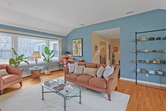 living room featuring lofted ceiling, wood finished floors, visible vents, and baseboards