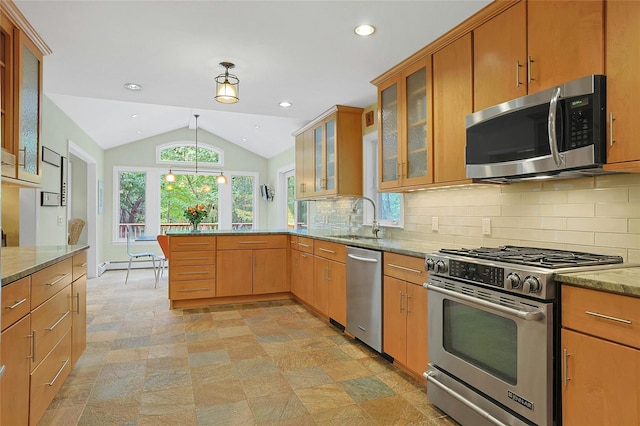 kitchen featuring stainless steel appliances, a baseboard heating unit, vaulted ceiling, a sink, and a peninsula