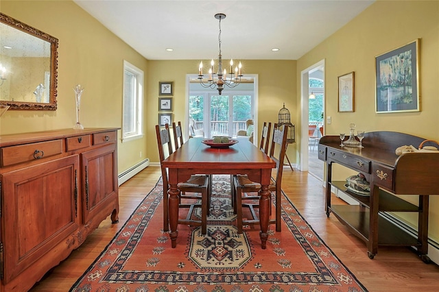 dining area featuring light wood finished floors, a baseboard radiator, recessed lighting, a chandelier, and baseboards