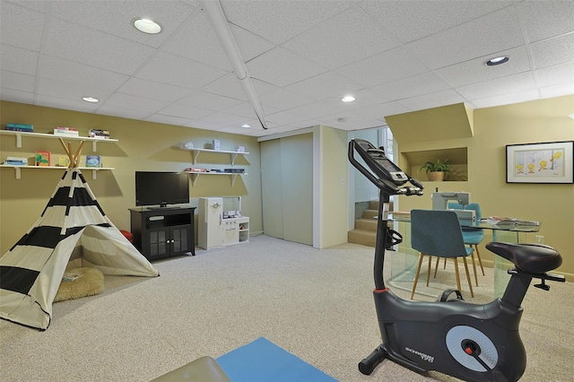 exercise area featuring baseboards, carpet flooring, a paneled ceiling, and recessed lighting