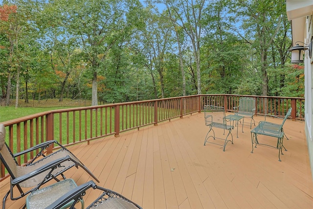 wooden terrace with a lawn