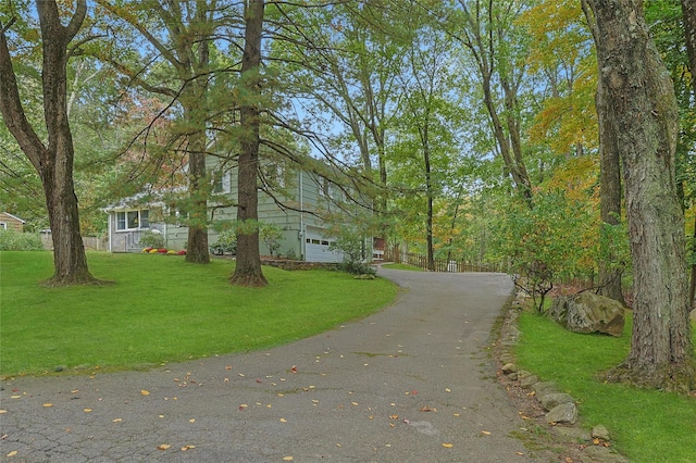 view of front of property with aphalt driveway and a front yard