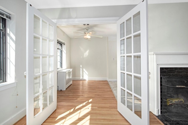 interior space featuring french doors, light wood-style flooring, and baseboards