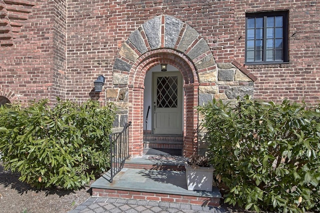 property entrance featuring brick siding