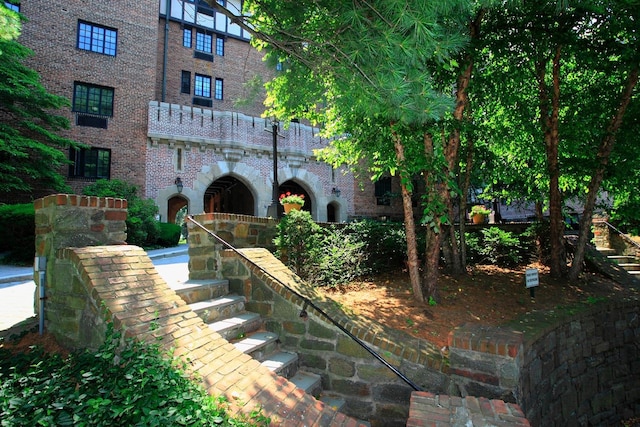 exterior space featuring brick siding and stairway