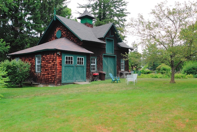 rear view of house featuring a yard