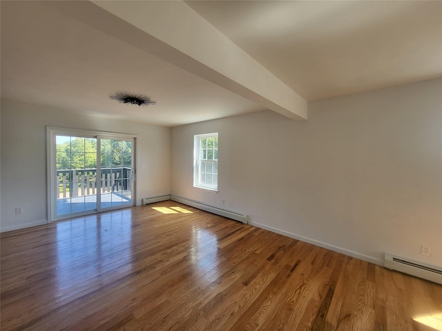 spare room with light wood finished floors, a baseboard radiator, and beam ceiling