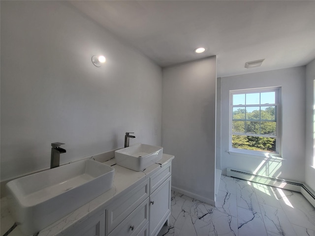 bathroom featuring double vanity, marble finish floor, a baseboard radiator, and a sink