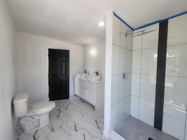 full bath featuring a stall shower, marble finish floor, a sink, and double vanity