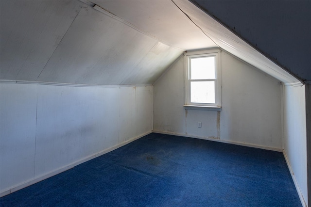 bonus room with carpet floors and vaulted ceiling