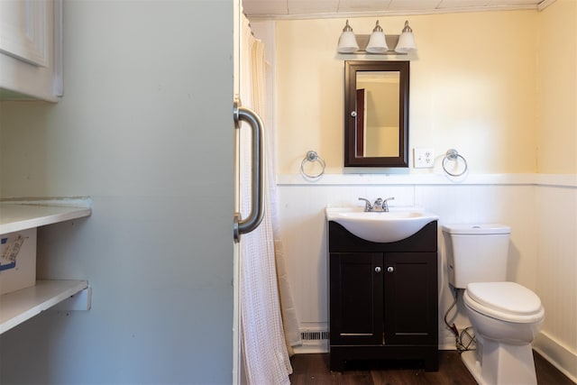 bathroom with toilet, vanity, a shower with curtain, and wood finished floors