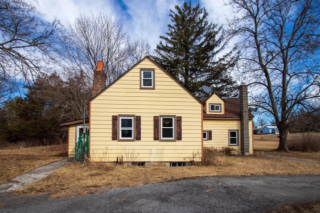 view of home's exterior featuring a chimney