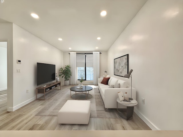 living room featuring light wood finished floors, baseboards, and recessed lighting