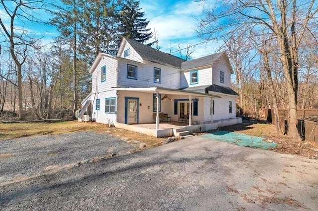 view of front of home featuring driveway and a patio area