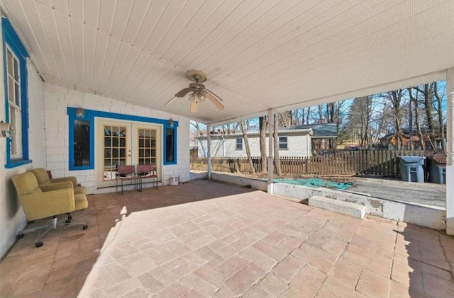 view of patio featuring french doors, ceiling fan, and fence