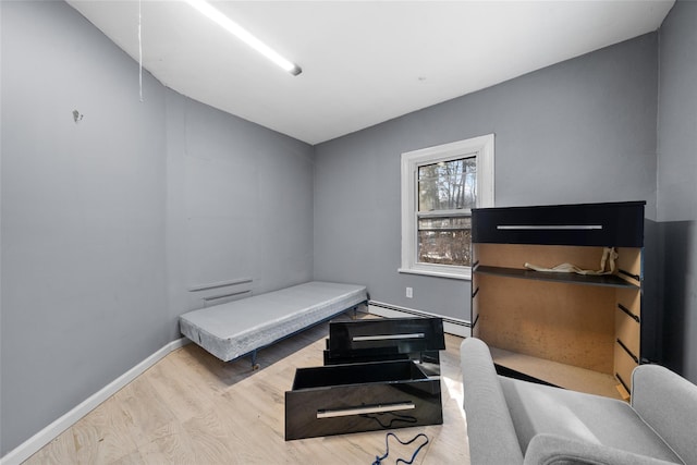 bedroom with baseboards and wood finished floors