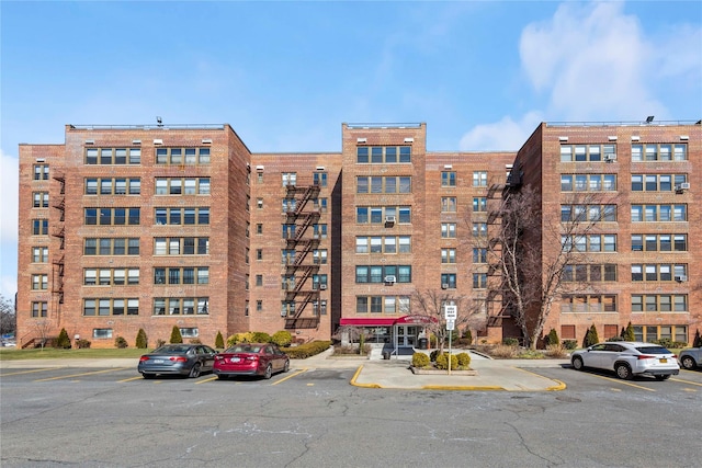 view of building exterior featuring uncovered parking