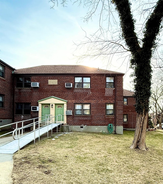 view of front facade featuring a front yard and brick siding