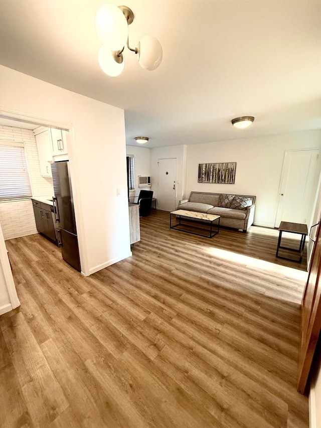 living area featuring light wood finished floors and baseboards