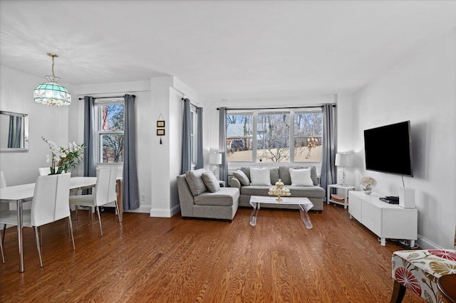 living room featuring dark wood-style flooring and baseboards