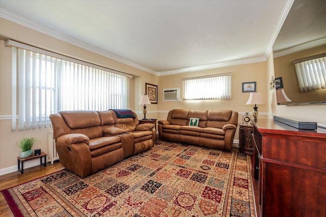 living area with crown molding, wood finished floors, baseboards, radiator, and a wall unit AC