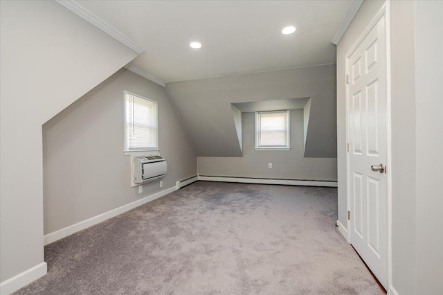 additional living space with a baseboard heating unit, healthy amount of natural light, baseboards, an AC wall unit, and recessed lighting