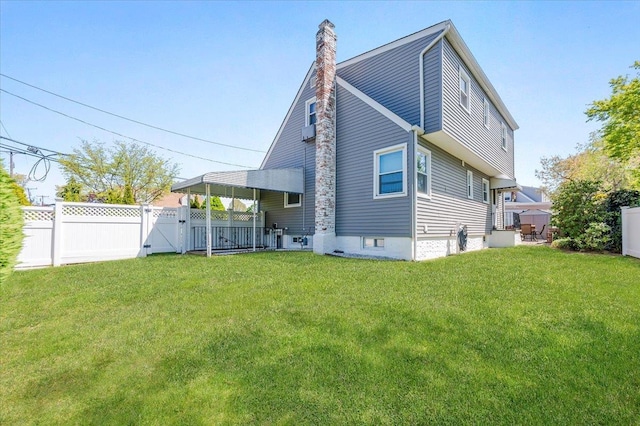 back of property with a gate and a chimney