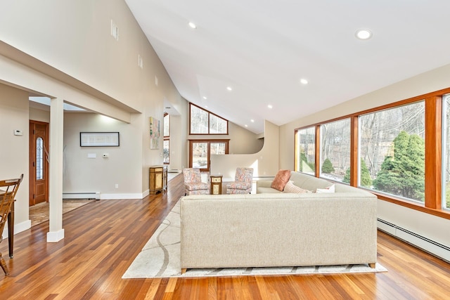 living area featuring a baseboard heating unit, baseboard heating, wood finished floors, and recessed lighting