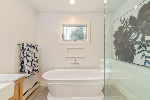 bathroom with a soaking tub, a baseboard radiator, tile patterned floors, vanity, and recessed lighting