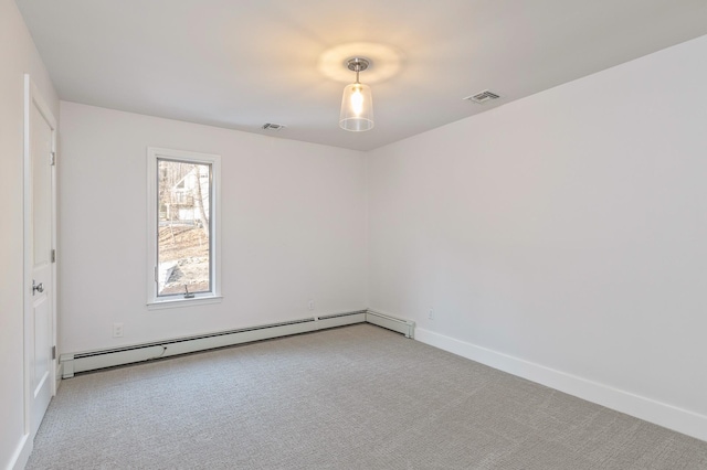 unfurnished room featuring light carpet, baseboard heating, visible vents, and baseboards