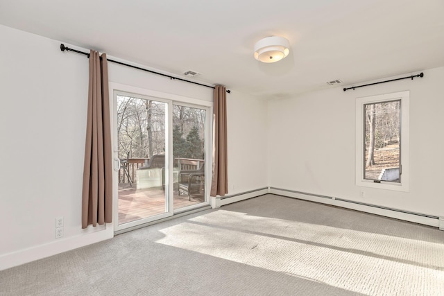 carpeted empty room with a baseboard heating unit, visible vents, and baseboards