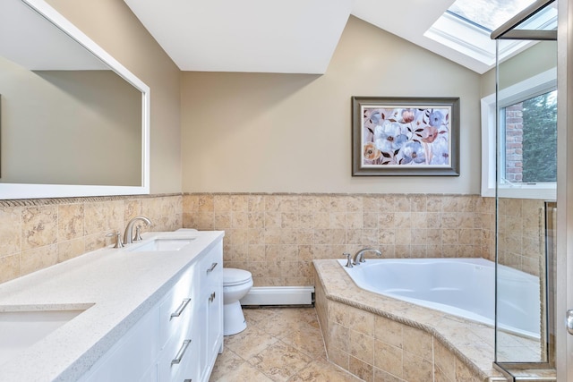 bathroom featuring a baseboard radiator, a garden tub, toilet, a sink, and lofted ceiling with skylight