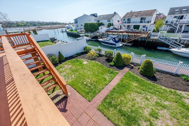 92 E First St, Freeport, NY 11520 - view of yard with a residential view, stairway, a fenced backyard, a boat dock, and a water view