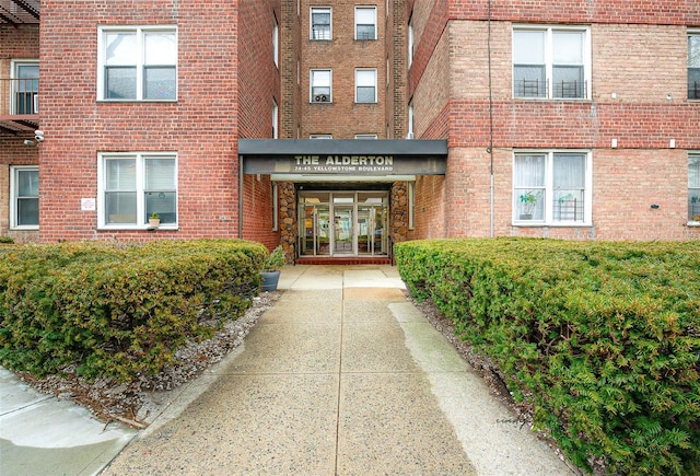 property entrance featuring brick siding