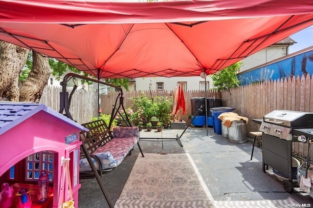 view of patio with a fenced backyard and area for grilling