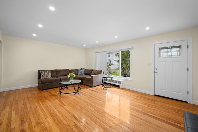 2057 Renfrew Ave, Elmont, NY 11003 - living room featuring radiator heating unit, light wood-style floors, baseboards, and recessed lighting