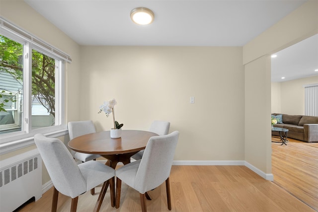 2057 Renfrew Ave, Elmont, NY 11003 - dining space featuring radiator heating unit, light wood-type flooring, and baseboards